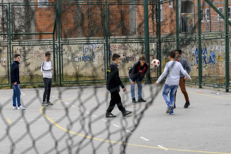 Children playing in a football field 