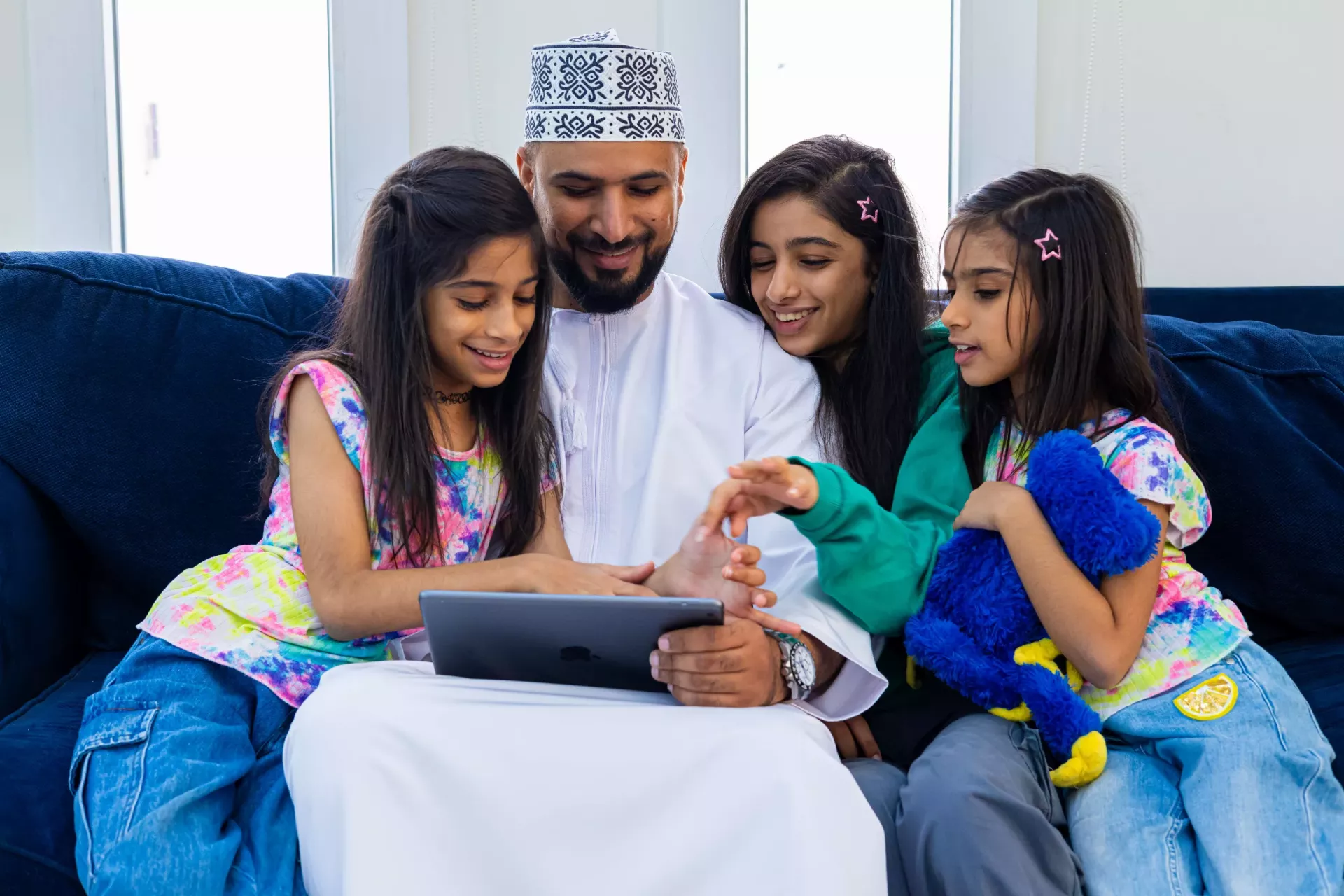A father with his daughters using I Pad - lovely moment 