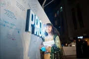 girl in front of the promise wall
