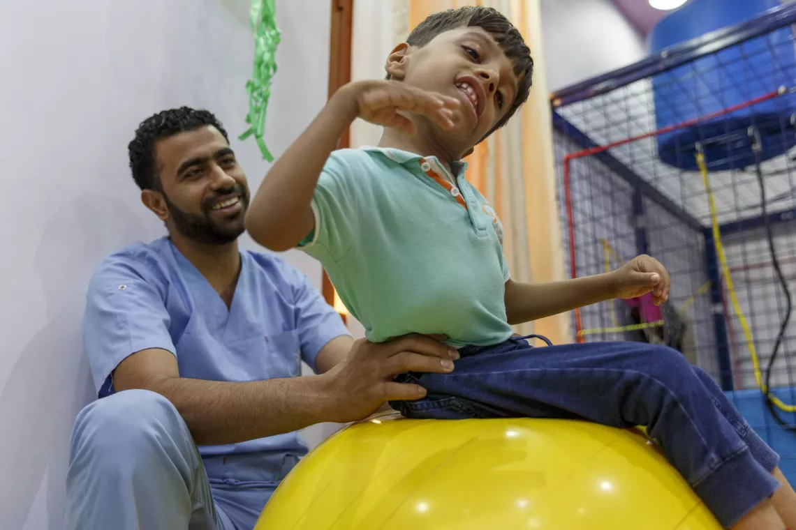 Disabled kid playing with the caregiver 