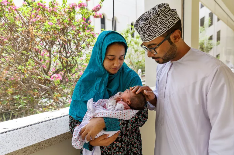 A father and mother with their new baby born 