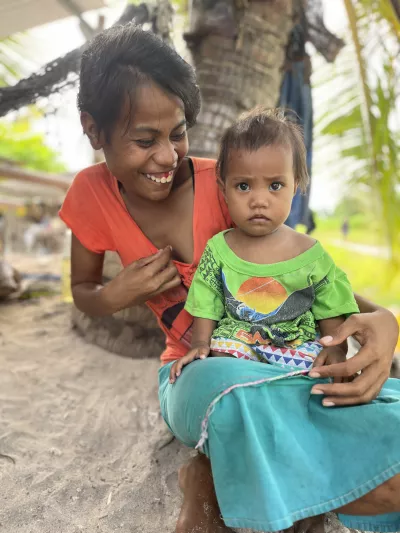 Beeta and her little girl Arona at their home in Poland, Kiritimati. Their family of four does not have a toilet, but Beeta is committed to building one with support from the BRIS programme.