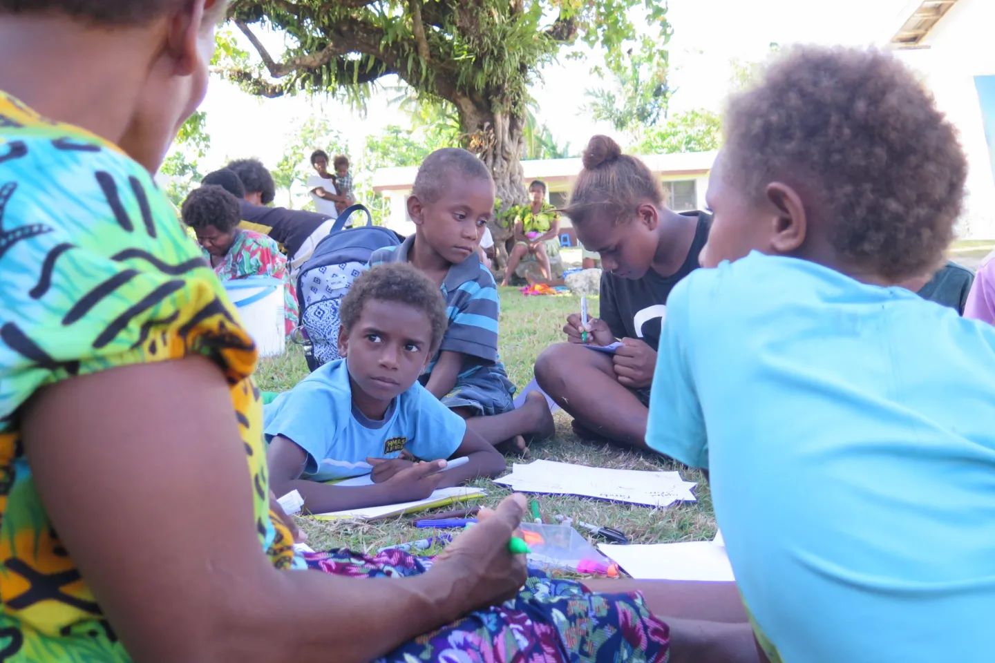 10 year old Castro from Vuigalato Village in Ambae chats with some of his friends at an early childhood space at an evacuation centre in Santo. 