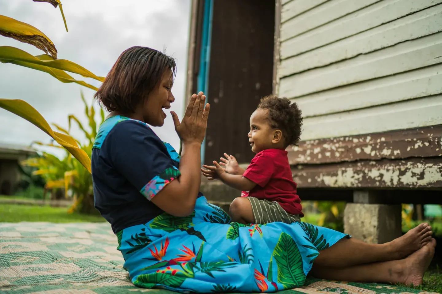 SUVA, FIJI - NOVEMBER 28, 2024: Kasanita Savoi plays with her 15-month old son, Pita Waqalevu in their village of Cautata in Central, Fiji.  UNICEF supports Early Childhood Development (ECD) in the Pacific by promoting good health, adequate nutrition, safety, responsive caregiving, and learning opportunities, while also addressing gender-transformative norms and violence prevention.