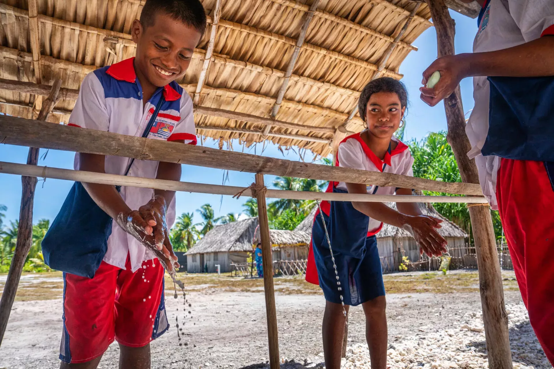 Students wash their hands during break time at Taiwan Primary School in Tebunginako, Abaiang Island, Kiribati.