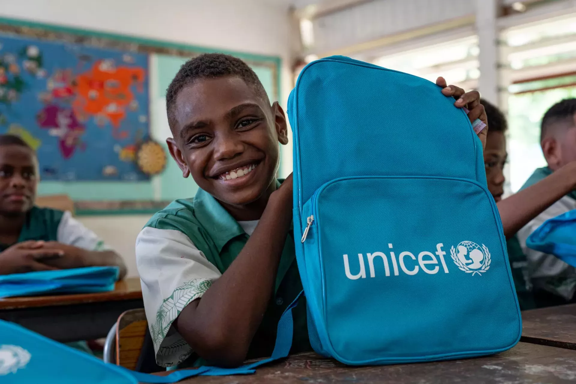Students of Central School, Port Vila, with their backpacks on the second day of school. These backpacks were distributed by UNICEF staff to children affected by the recent earthquake.