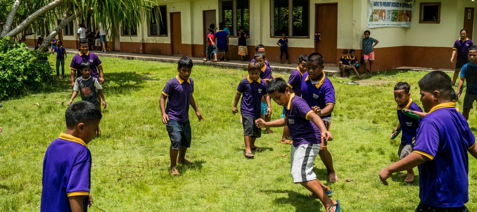 school children play football in FSM