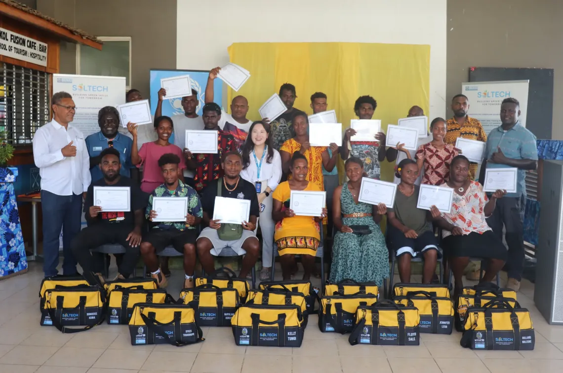 SolTech graduates display their certificates after completing training in solar installation and renewable energy systems 