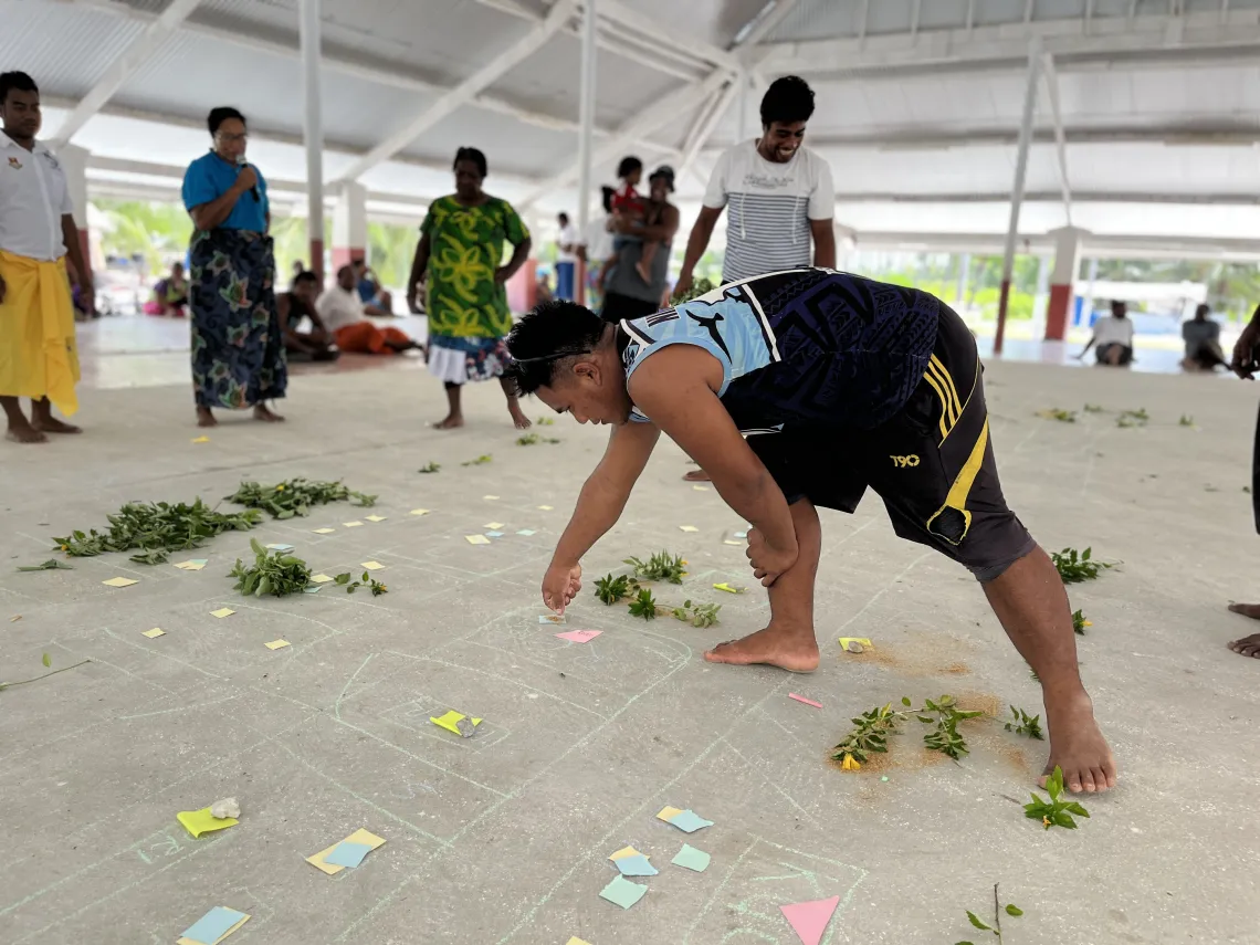 Community members in Kiritimati map their village as part of the CLTS process and identify areas where people defecate in the open.