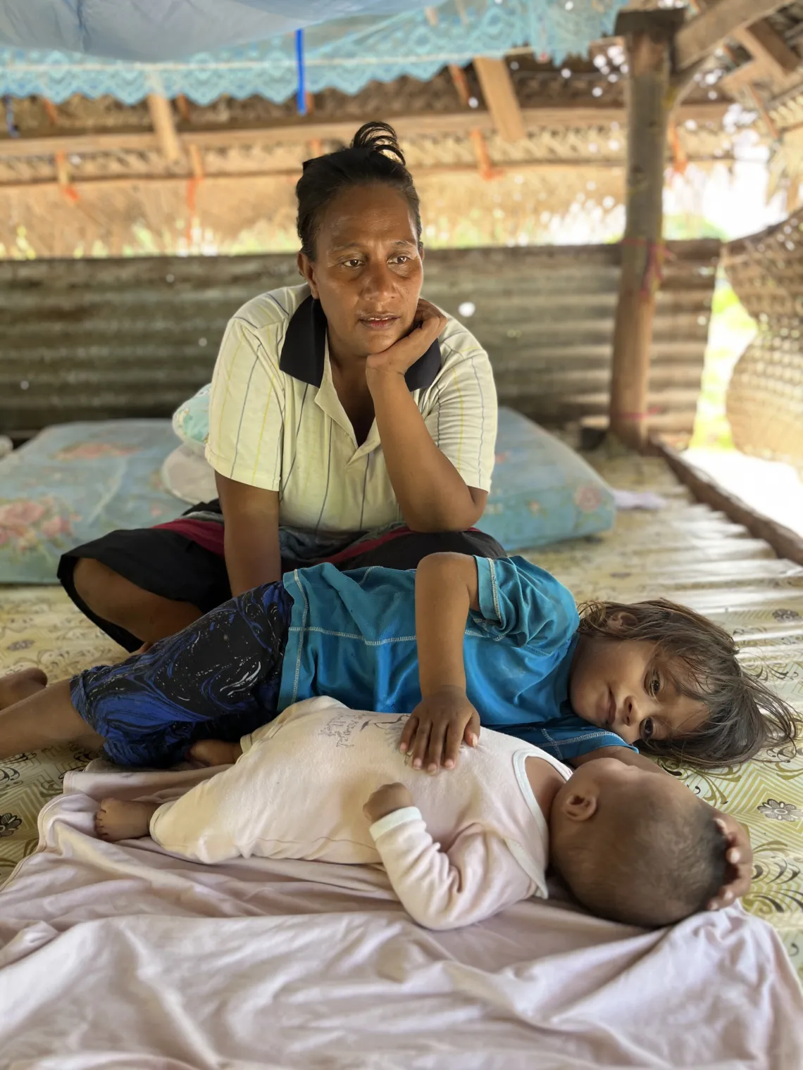 Terauea and her two children at their home in Poland, Kiritimati.