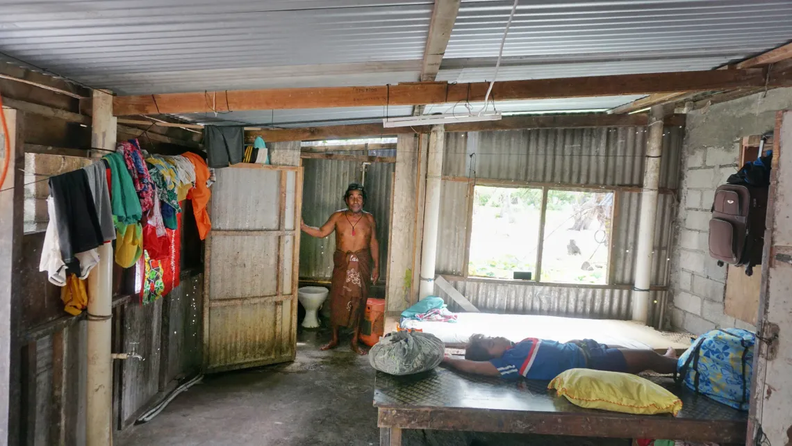 Kianteroro stands by his new toilet inside his house in Kiritimati island in Kiribati, 