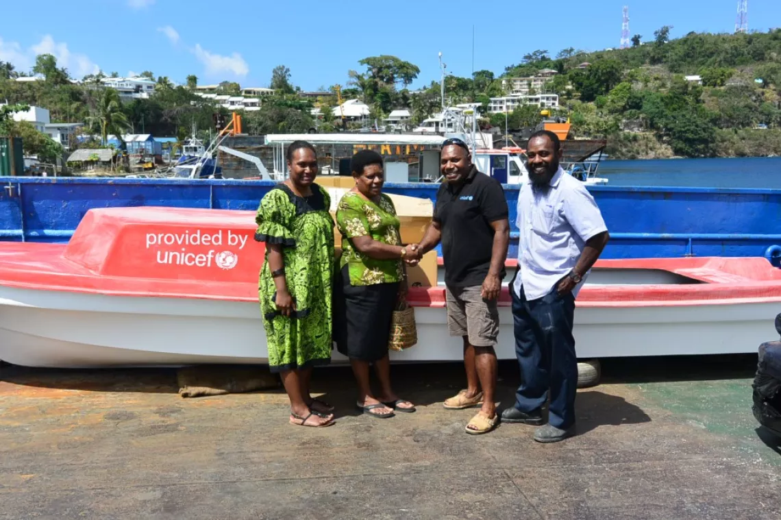 (L-R) Leinasu Abel, Admin Officer and Lucie Molgos, Acting Director for Civil Registry, with UNICEF Child Protection Officer, Joemela Simeon, for the handing over of the 7m fibreglass boat in Port Vila on Wednesday 11 October 
