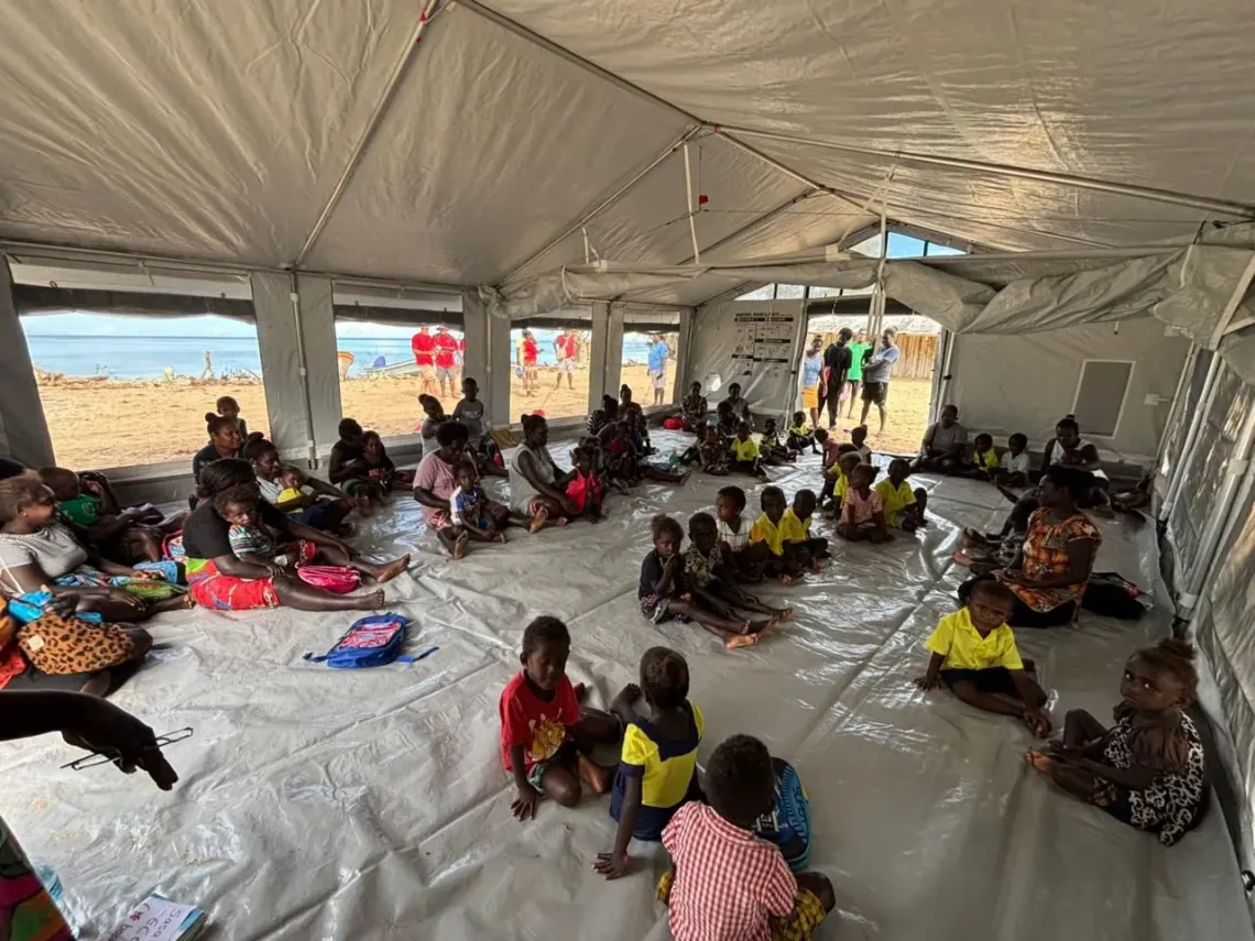Children gather inside a UNICEF-supported temporary learning space in Choiseul Province. Beyond education, the space also provides emotional support through Psychological First Aid sessions delivered by trained community facilitators, helping children cope with fear, loss and uncertainty after the cyclone.  