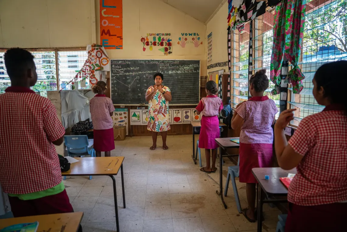 A teacher educates hearing-impaired students in sign language at The Red Cross Special Development Centre, a school dedicated to children with special needs in Honiara, Solomon Islands.
