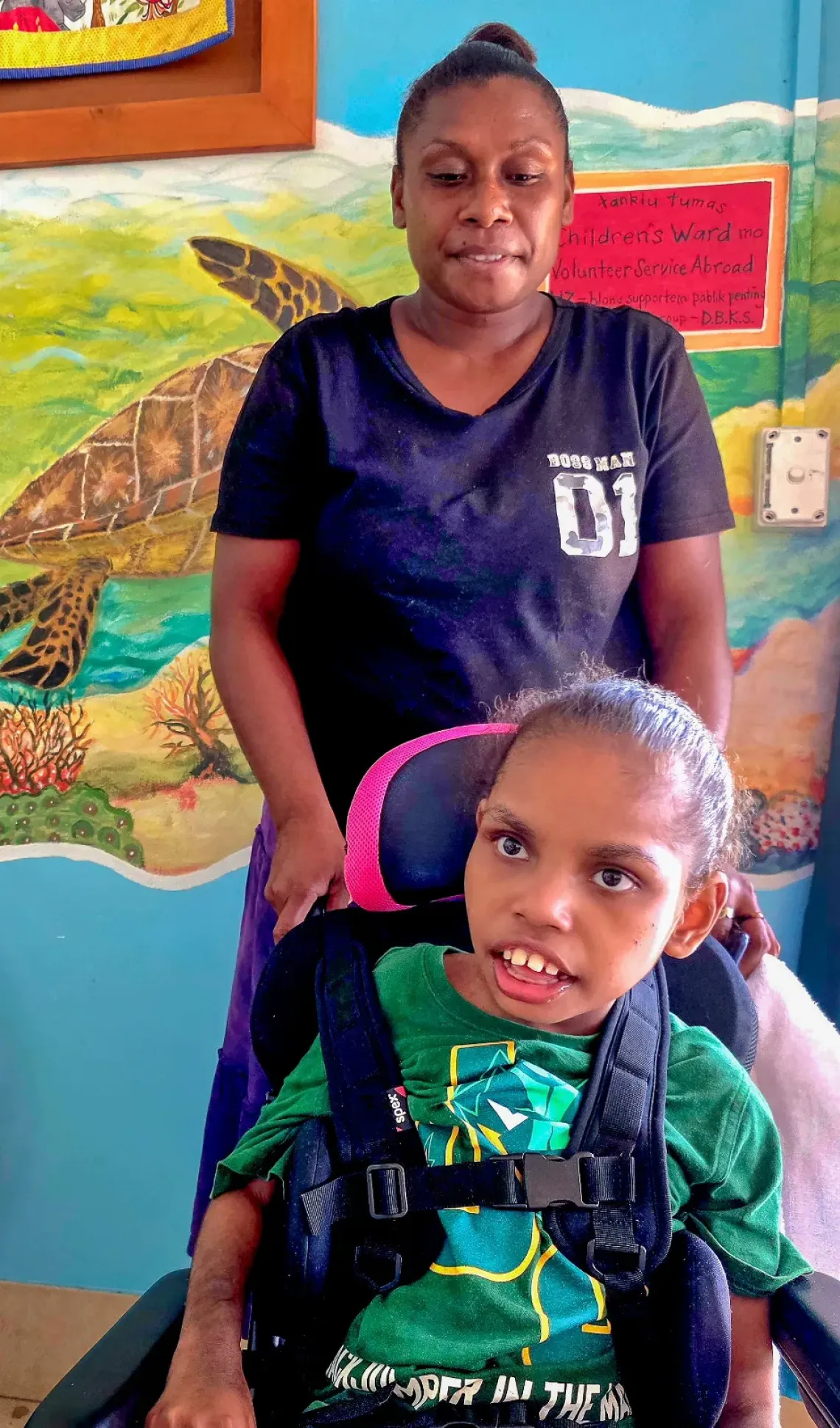 Dorothy and her mother, Jessica, receiving a new wheelchair at Vanuatu National Hospital