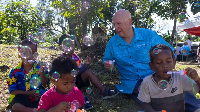 UNICEF Pacific Representative, Hamish Young, with children at the official launch of the Bebbo Pacific App in Fiji