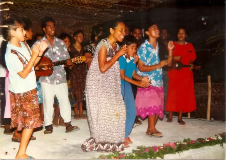 Carnita in a pink skirt with Darlene Keju Johnson and Youth to Youth in Health in 1992.