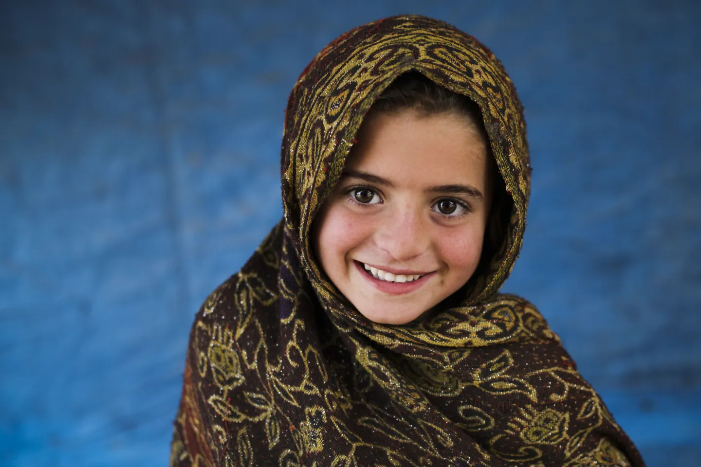 4 year old Arifa stands outside her tent in Jalozai Camp, KPK province in Pakistan