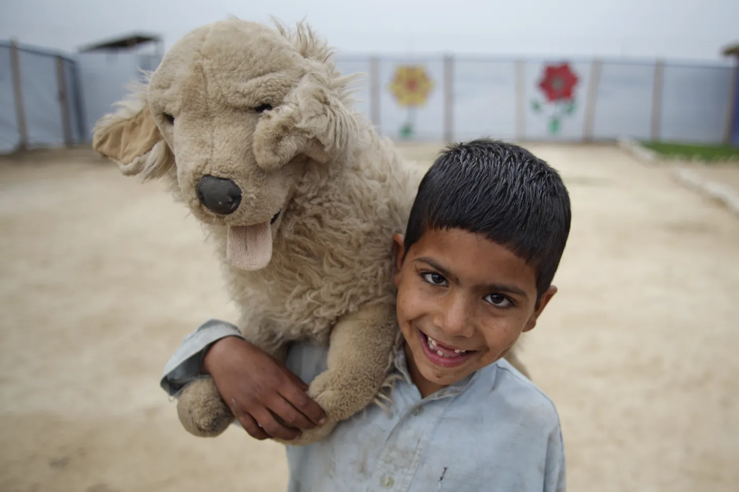 5 year old Daniyal plays with a stuff toy in Jalozai Camp, KPK province in Pakistan