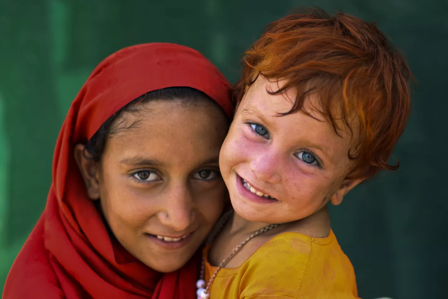 13 year old Nazo with her 3 year old Zareena in a camp
