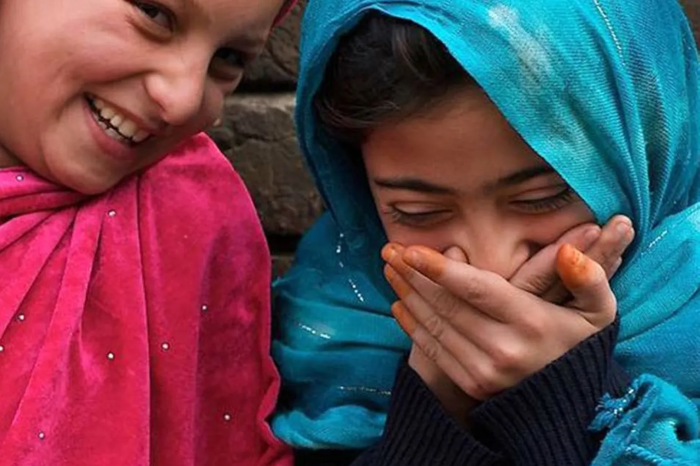 The Image shows two girls laughing