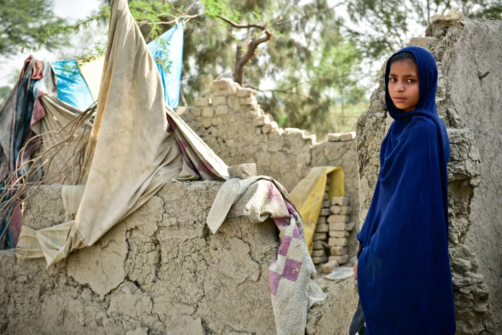 Mehreen stands in front of her destroyed house