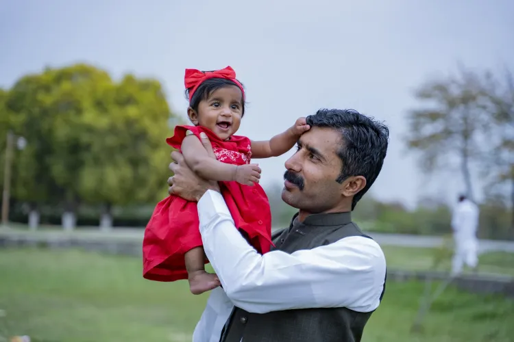 A father holds his daughter