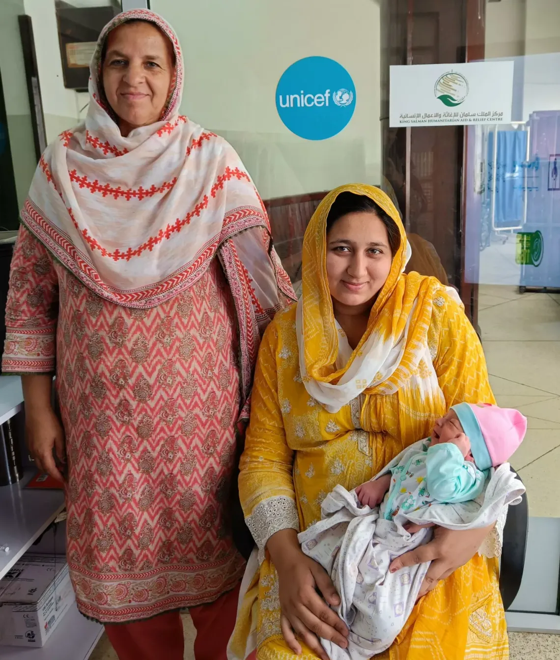 A newborn baby with his mother and grandmother