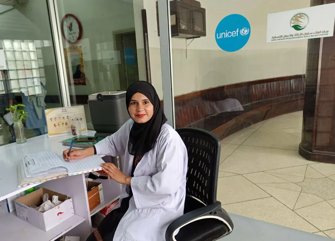 Ayesha Bibi updates the daily vaccination records at PIMS hospital.