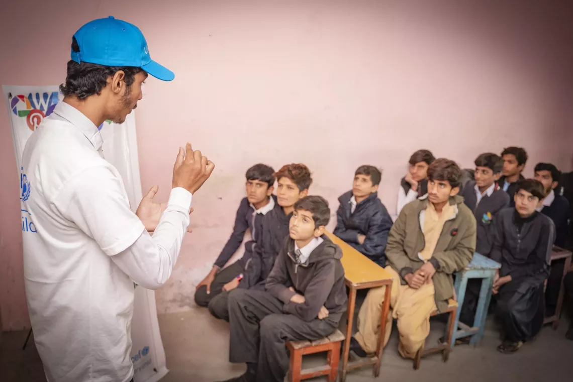 Shahzeb coaches children at Ali Oxford Public High School on how to stay safe while exploring the digital world. He guides them on how to identify and report bullying, set strong passwords, and protect personal information. 