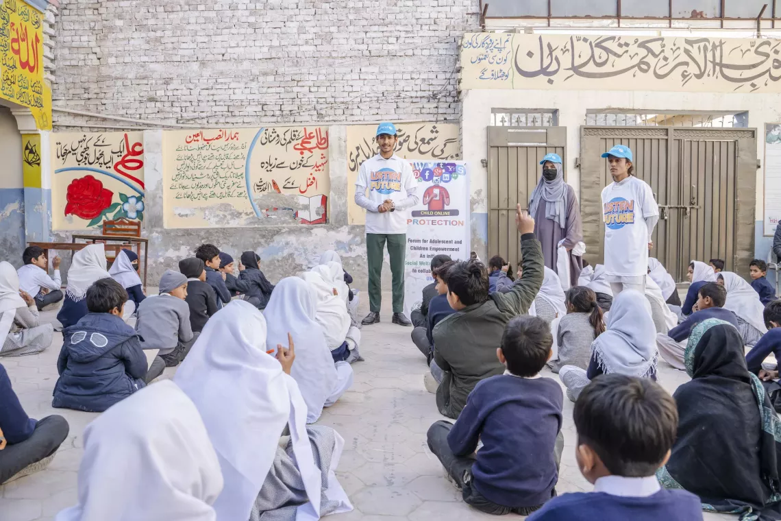 Shahzeb answers questions from children during an awareness session on protecting personal information and safely connecting to online spaces at Ali Oxford Public High School, Rajanpur.