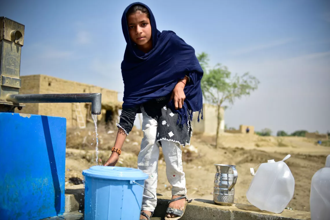 Mhreen fills water from a handpump