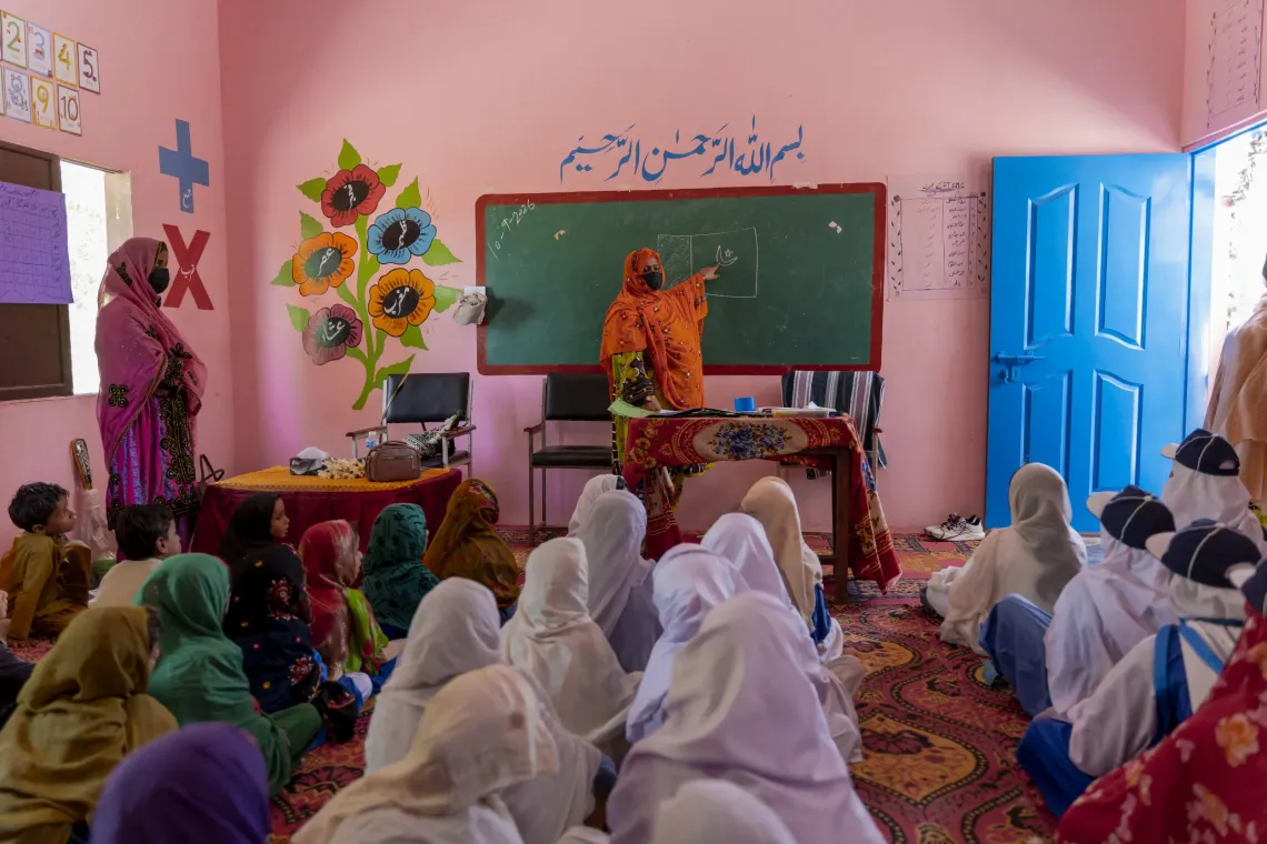 Azra Bibi, one of the two teachers at Government Girls Primary School in Lasbela, teaches her students with confidence and renewed engagement following the reconstruction and improvement of the school and its facilities.