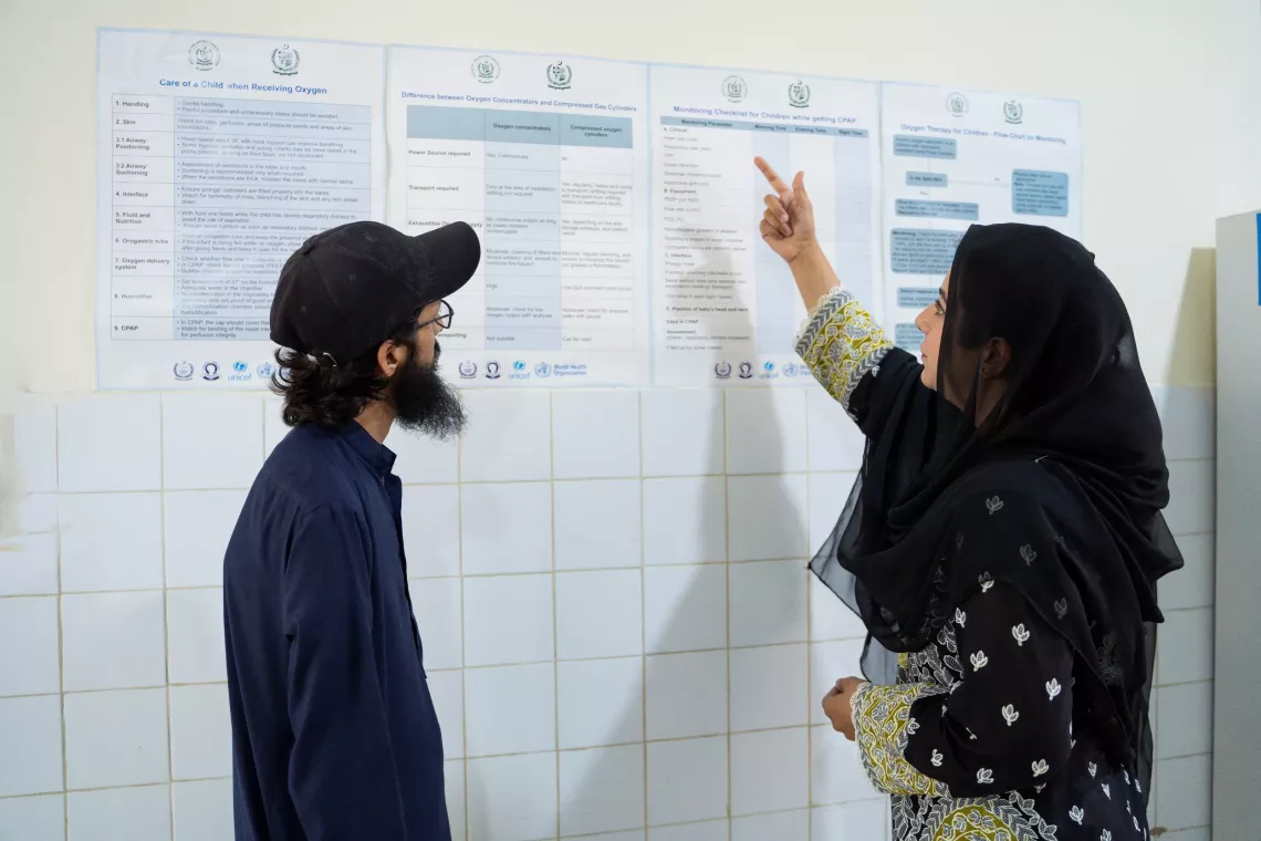 Dr. Samia and her assistant review the Oxygen Therapy Checklist and Guidelines provided by UNICEF at the Rural Health Centre in Barakahu, Islamabad. 