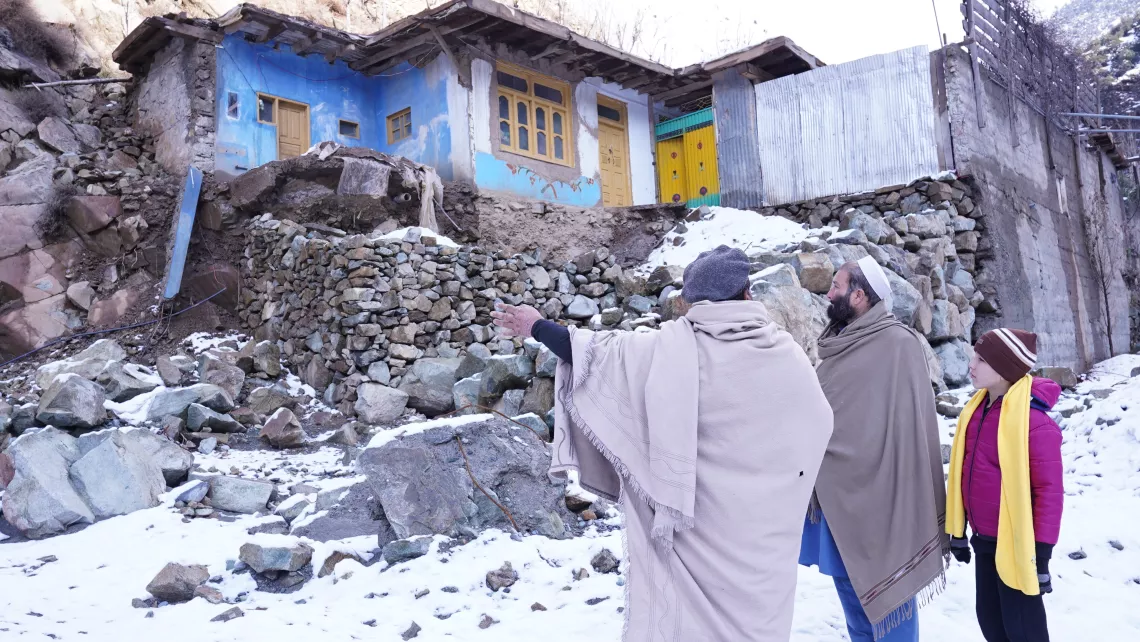 Noorullah’s grandfather (left) and father (centre) show the damage caused by the floods to their house and the section they managed to rebuild. 