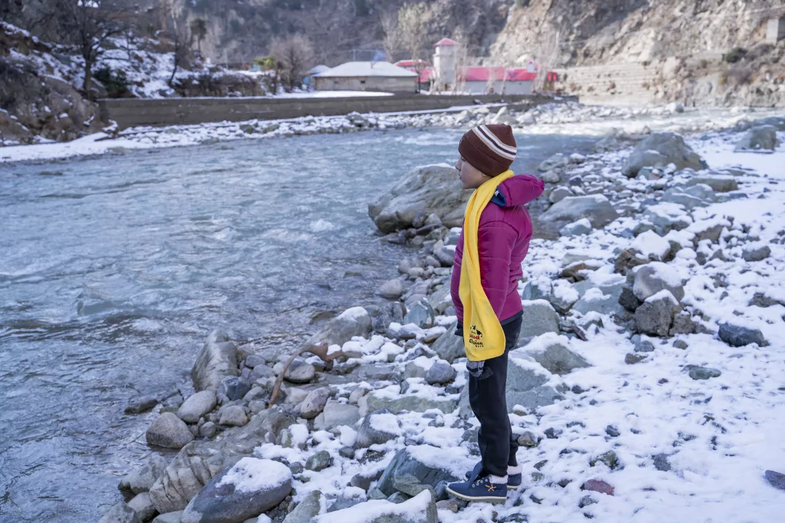 Noorullah stands on the bank of River Panjkora next to his house in Sulool Daramdala village, Upper Dir District, Khyber Pakhtunkhwa.