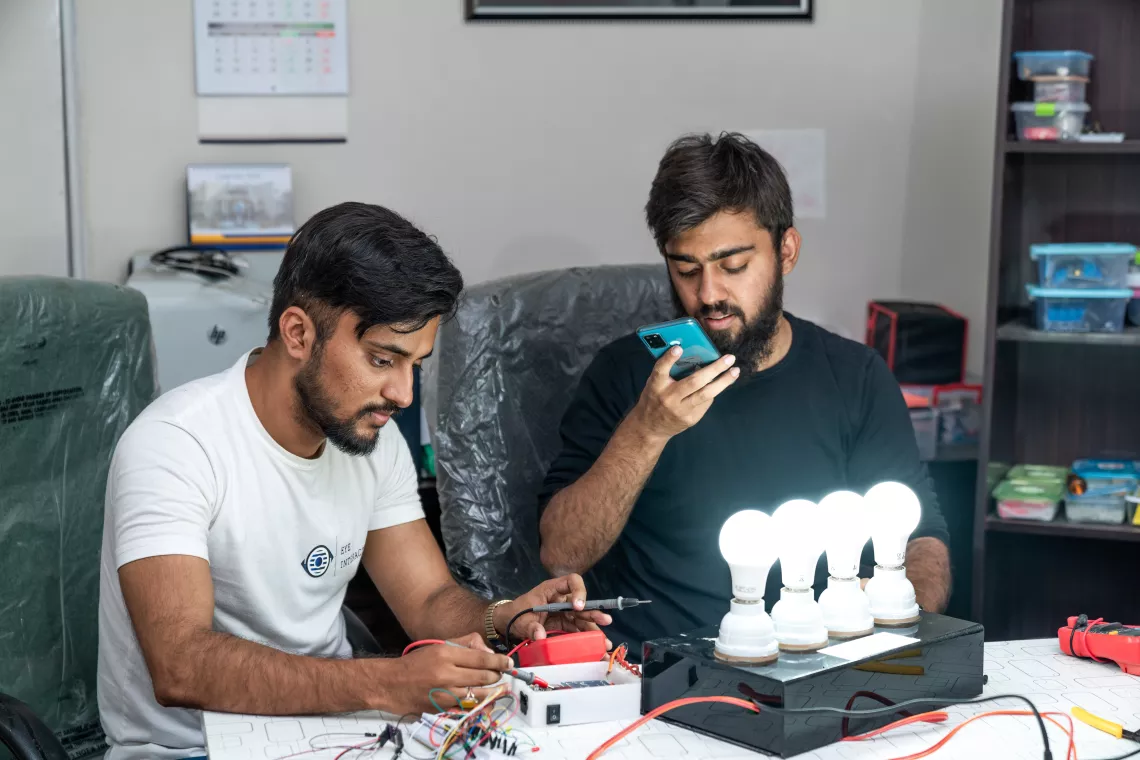 Irfan and Adeel working on their home automation system at their office in Karachi.