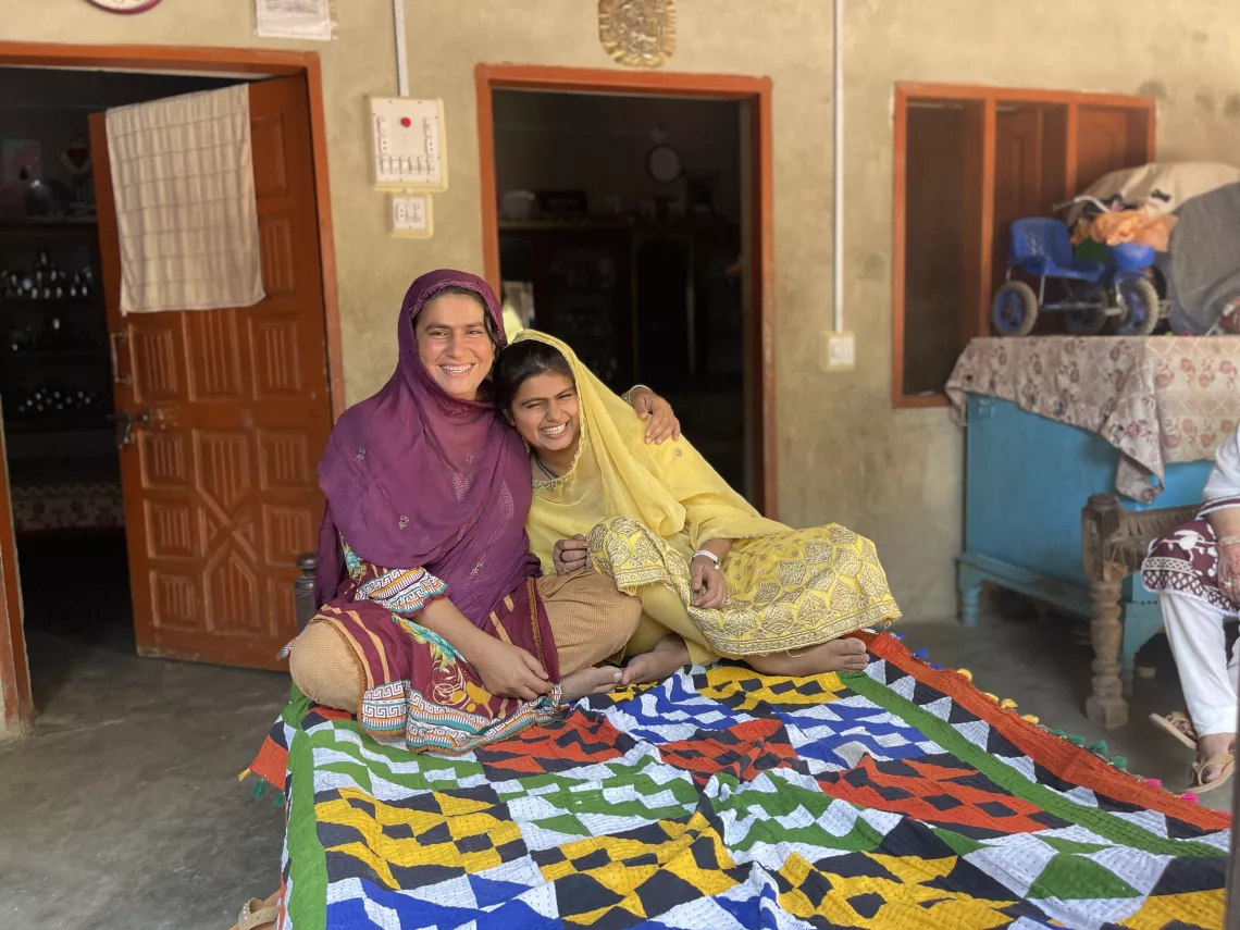 Firdous Bhatti (16) shares a moment with her mother after returning from the Non Formal Education Center, Qadirpur Village, Ghotki District, Sindh. 