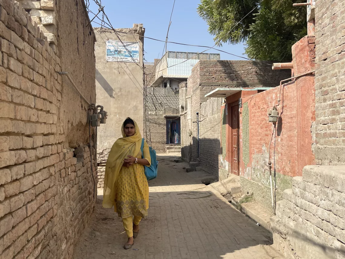 Firdous Bhatti (16), walks home from her school, the Non Formal Education Center, Qadirpur Village Ghotki District, Sindh.