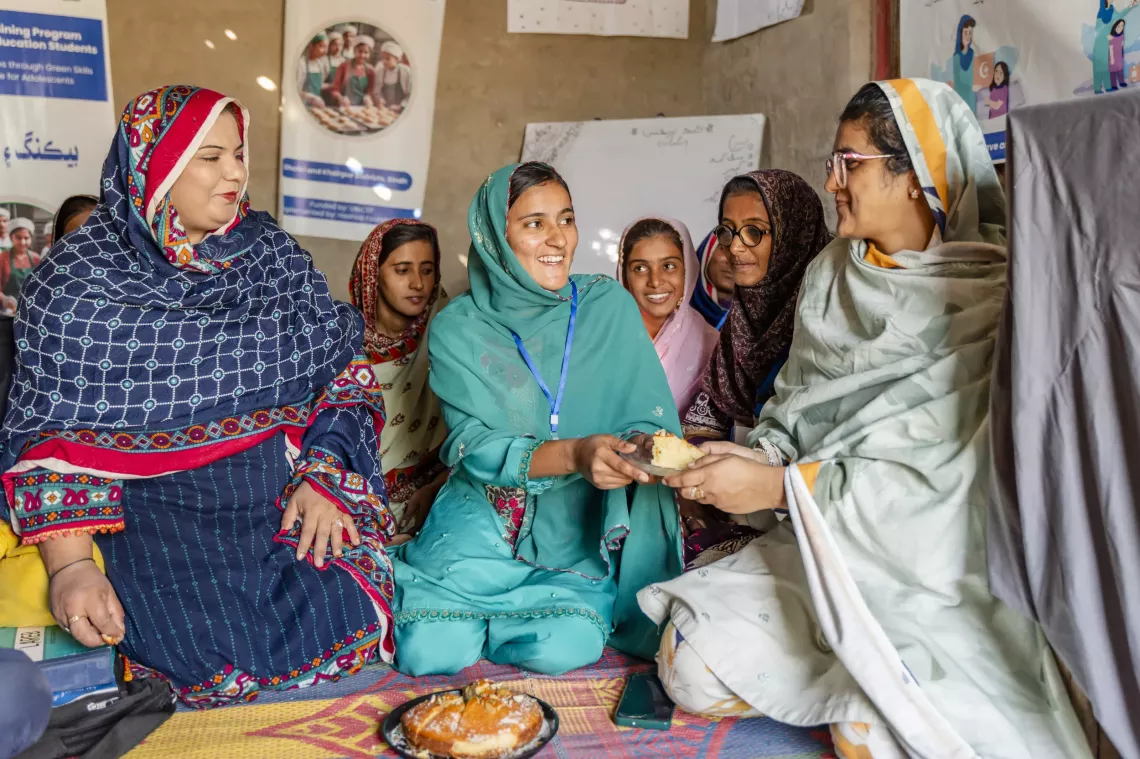Ayatul (Centre) is sharing hot cake with Dr. Azra Amber (Right), Youth Champion Officer from Indus Resource Centre as the trainer from Hashoo Foundation Paro Mehdi (left) looks on. 