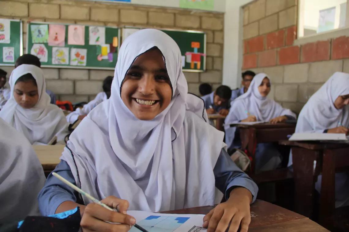 Javeria in her class room along with other students.