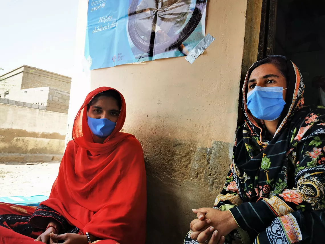 Fazeela sits with Mahira, the oldest student at the centre and also her informal assistant.