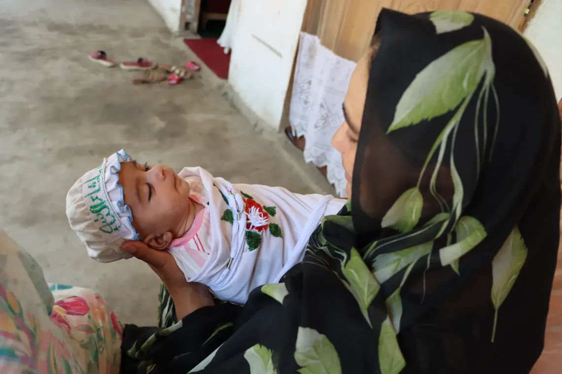 Ms. Habiba holds her newborn son, Salman.