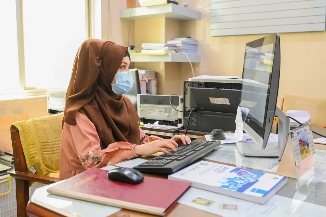 Data Entry Operator Sumaira inputs patient data from registers into the DHIS2 online portal at the Shaheed Benazir Bhutto Hospital in Quetta, Balochistan. 