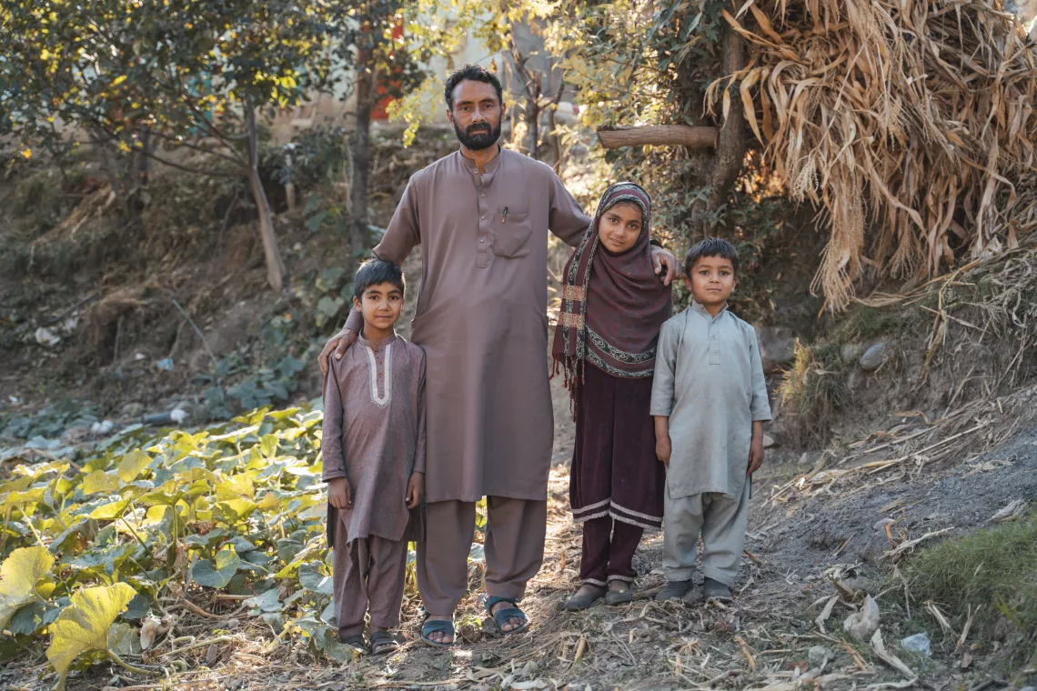 Suleman (centre) with his children Raishma (8), Hazrat Hussain (5) on the left and Akhter Hussain (6) on the right, is happy with the restoration of the water supply at his home. 
