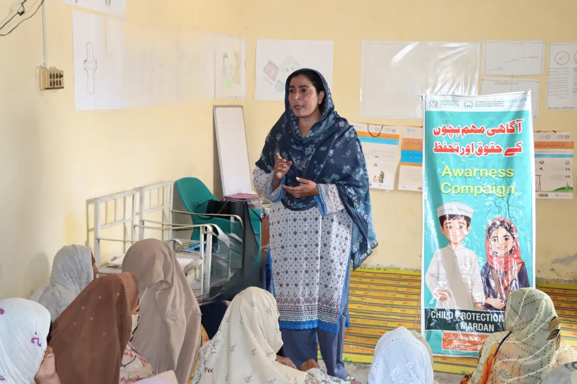 Shaheen conducts an awareness session on child marriage and child rights for women and girls in Khazana Deri at her home in Mardan. 