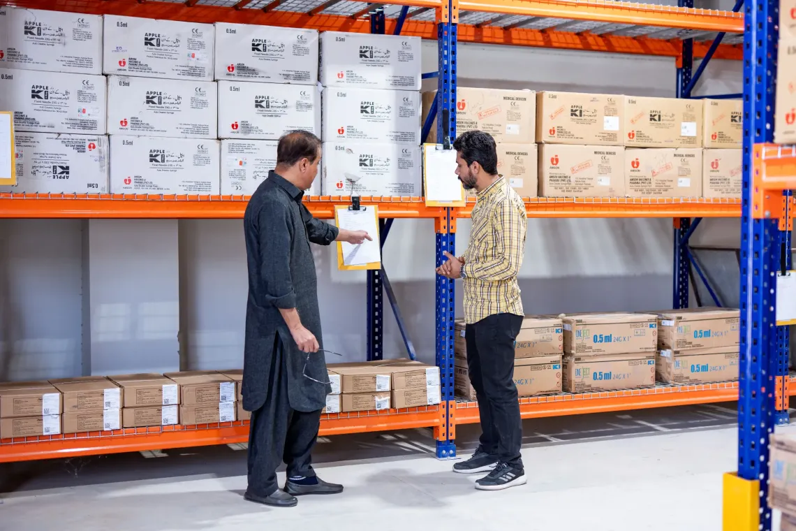 UNICEF Health Specialist, Dr Amir Akram, and Deputy District Health Officer, Dr Malik Mansoor, inspect the inventory list at the warehouse in Uthal, Lasbela District. 