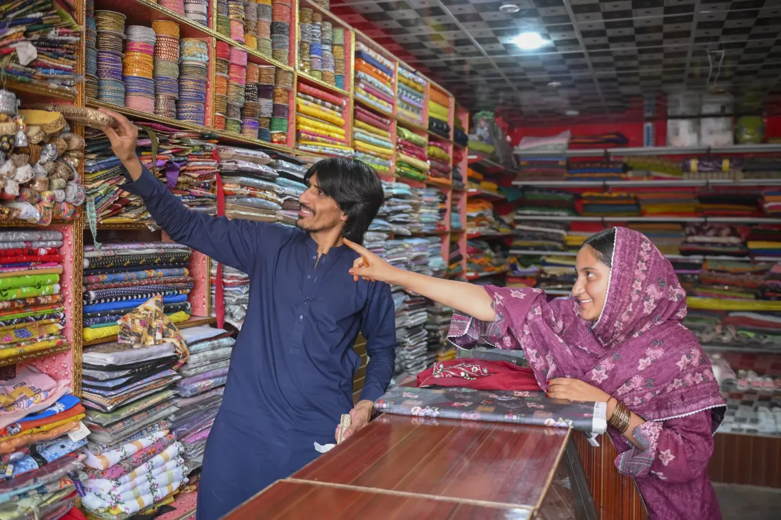 Yasmine conveniently shops unstitched cloth and related dressmaking items from her uncle&rsquo;s shop located next to her workshop.  