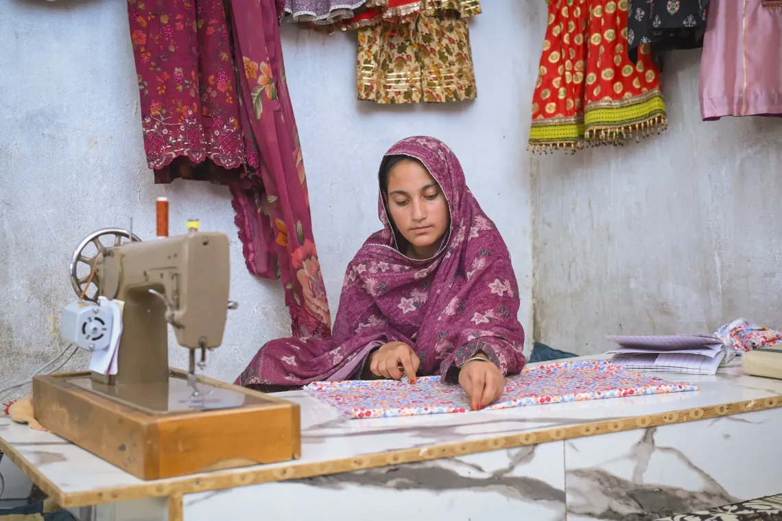 Having learnt the art of dressmaking at a UNICEF-supported ALP centre, Yasmine (16) has set up her own workshop and makes traditional dresses to sell in the local market.