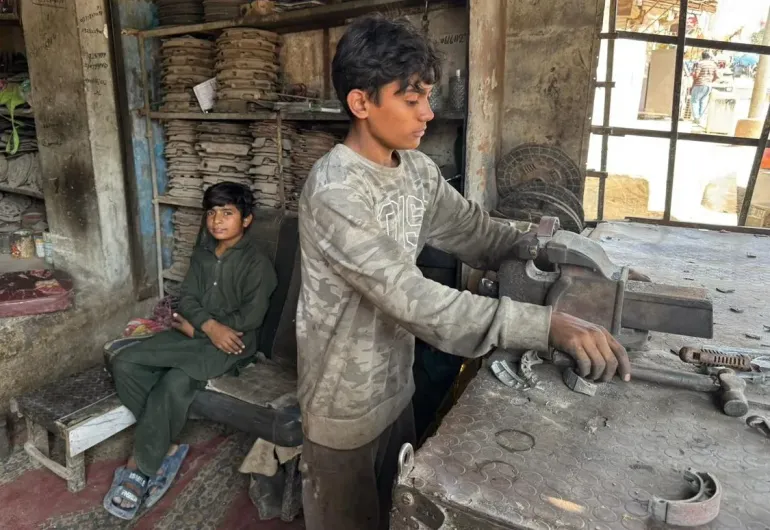 Children working in a mechanic shop in Karachi